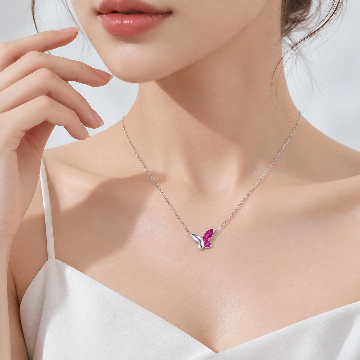 Blush Flutter Necklace worn on model with delicate pink zircon and sterling silver butterfly pendant