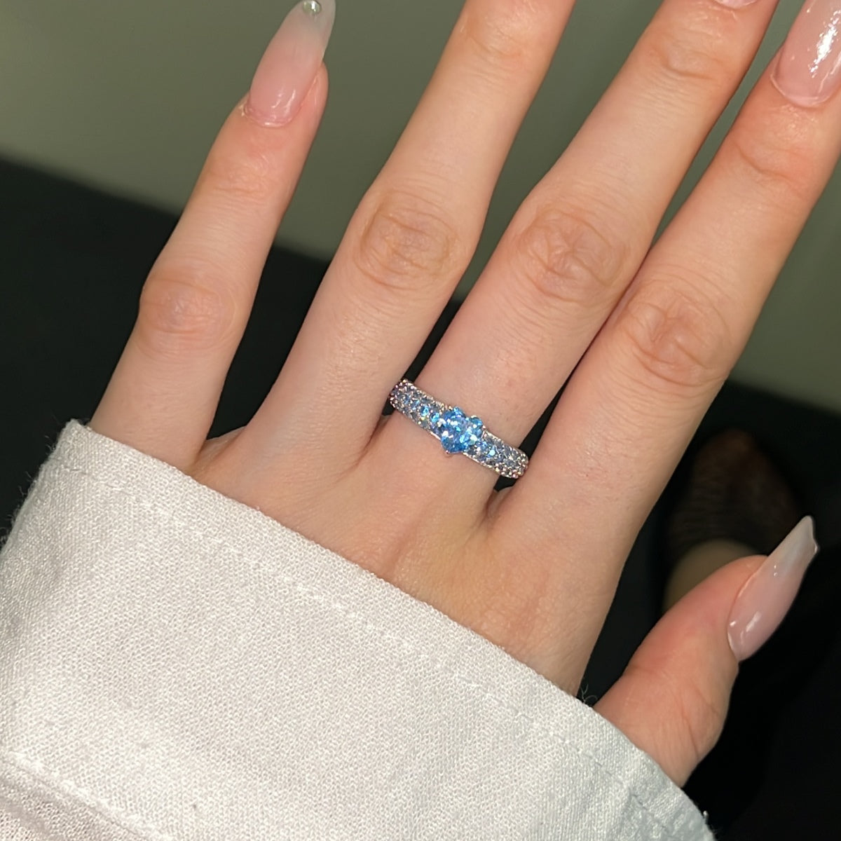 Sterling silver ring with icy blue heart-shaped centre stone and sparkling clear stone band